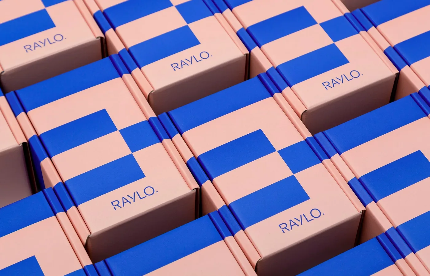 Raylo packaging boxes in soft pink carrying the two-colour switch pattern in pop blue