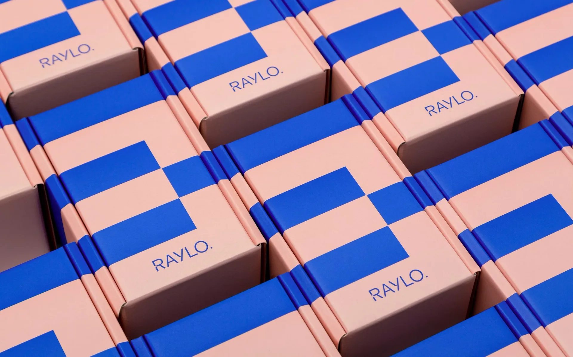 Raylo packaging boxes in soft pink carrying the two-colour switch pattern in pop blue