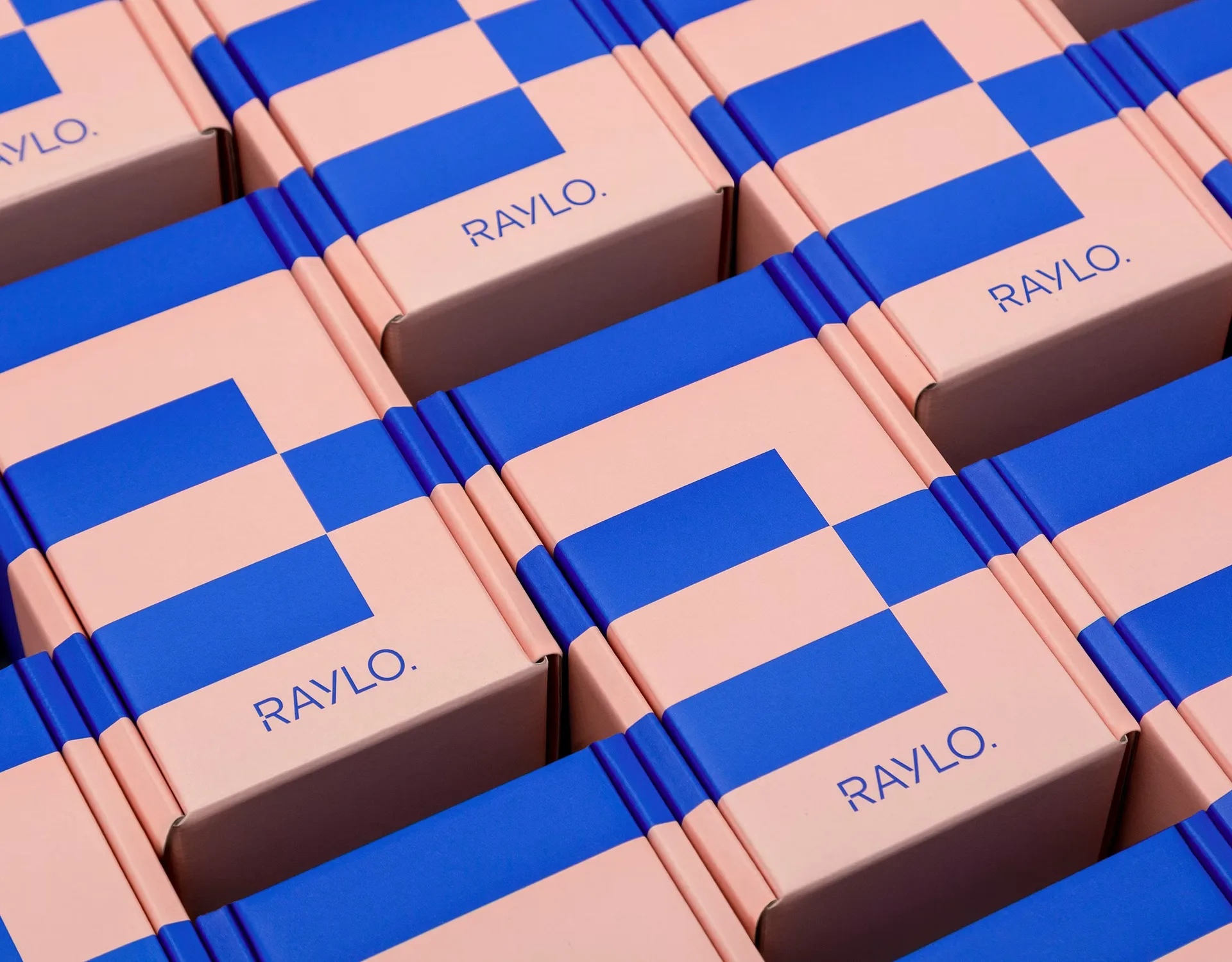 Raylo packaging boxes in soft pink carrying the two-colour switch pattern in pop blue