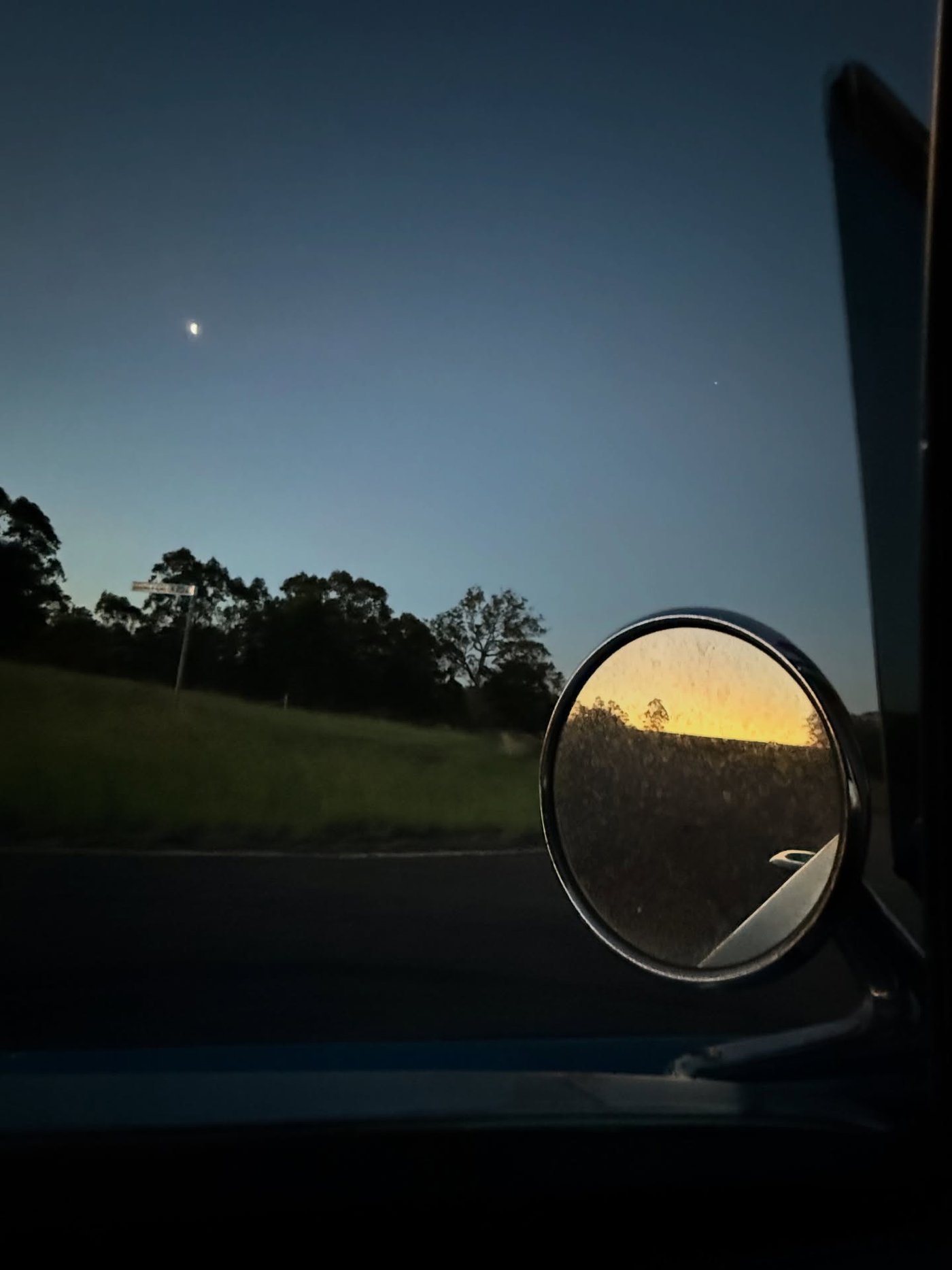 View from Jen’s car while driving in Dederang, Victoria, with dusk light reflected in the side mirror.