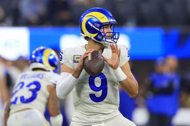 Matthew Stafford throws four touchdowns, leading the Rams to victory over the Vikings in an NFL matchup.