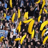 Why do Manchester City fans wave inflatable bananas?