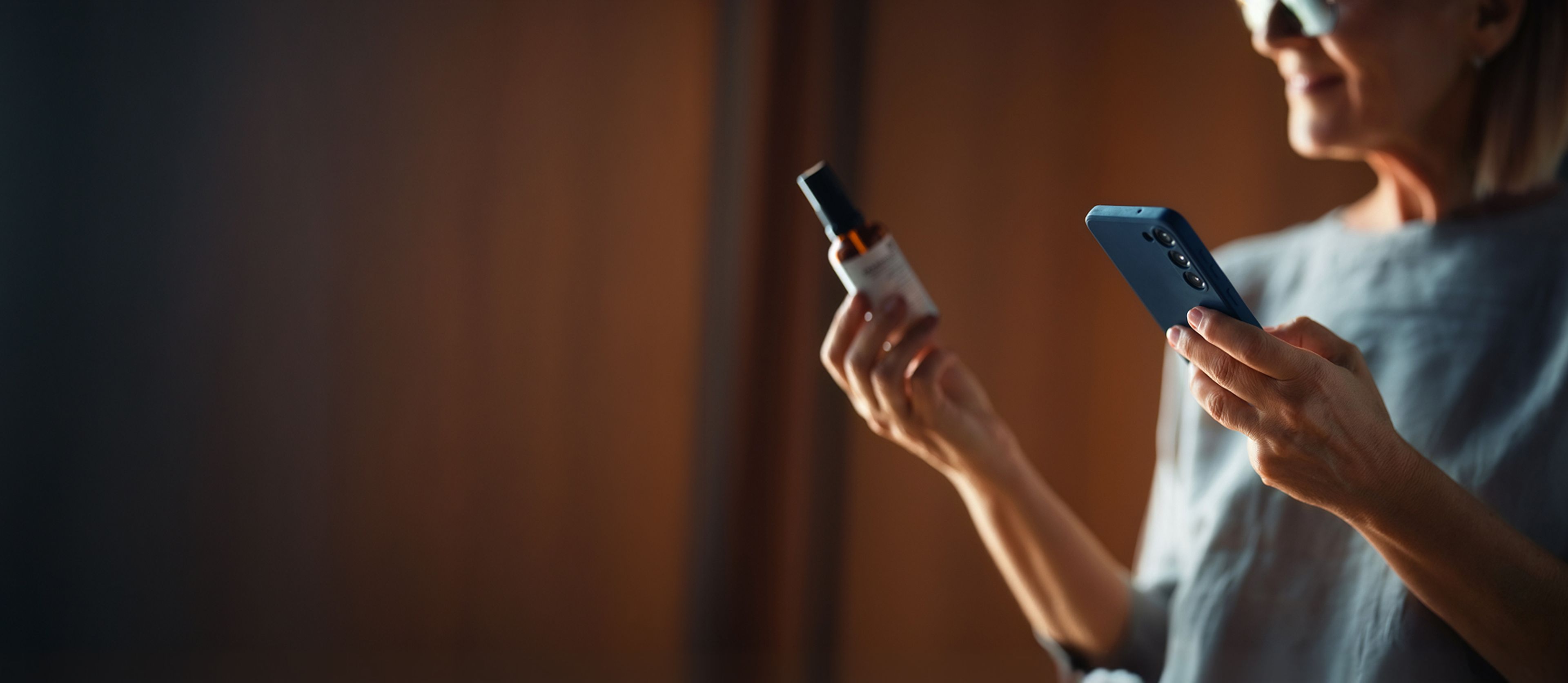 Person scanning a product bottle with a smartphone.