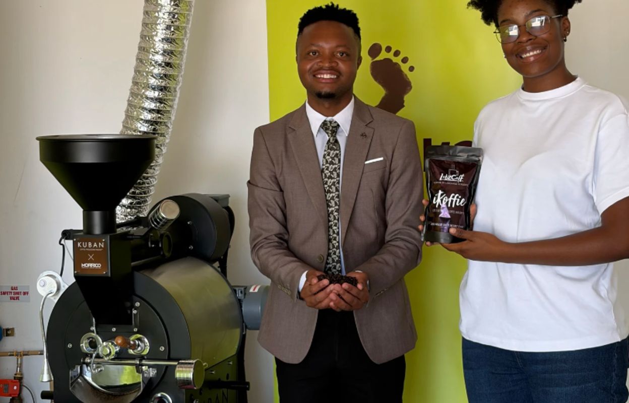 Owners of Lebz Café standing in front of their coffee counter.