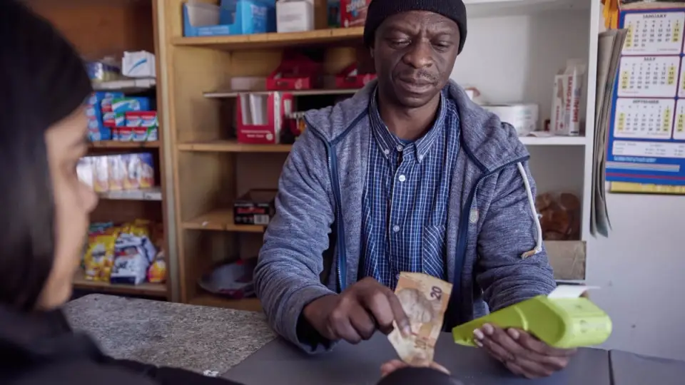 Store owner using fintech machine