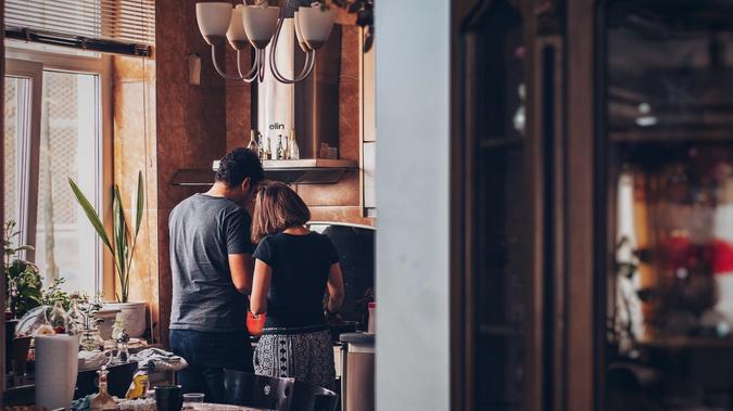 Couple at the kitchen preparing food