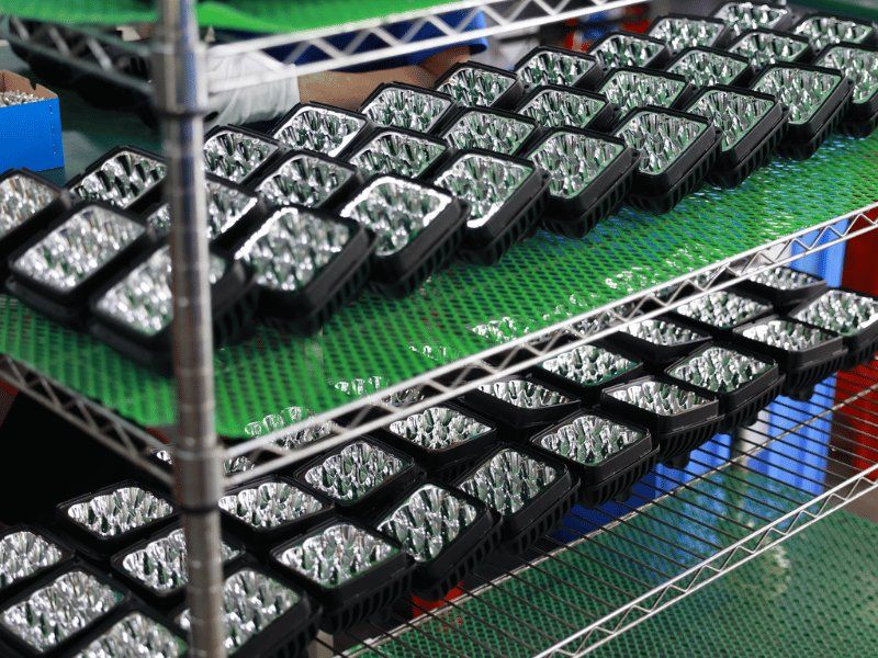 Racks of semi-finished LED work light assemblies in volume production