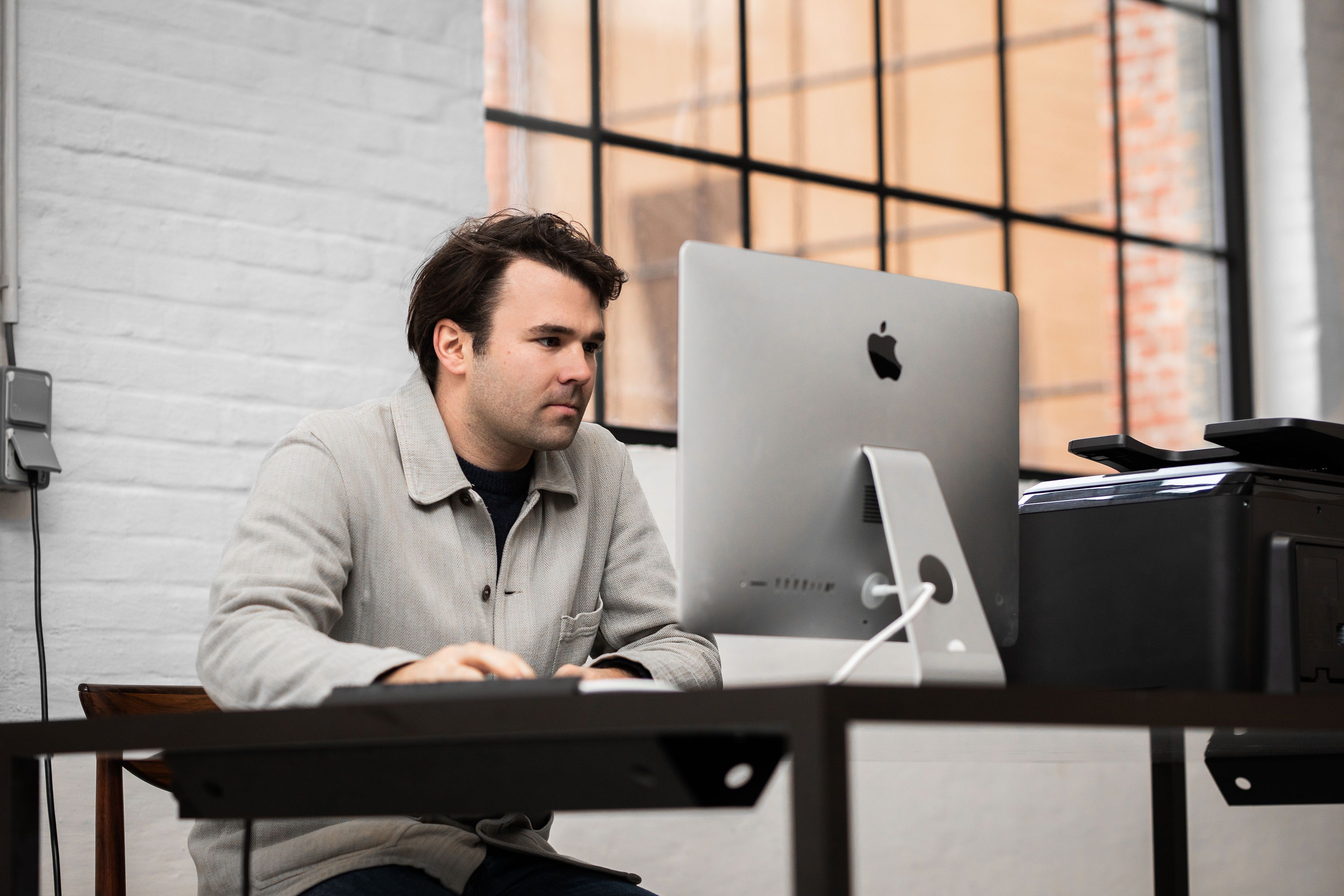 Nils de Chevigny working at his computer 