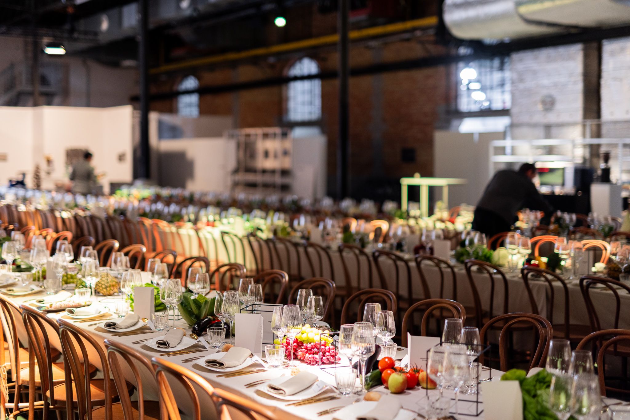 Guests at a long lunch table during an off-site VIP visit.
