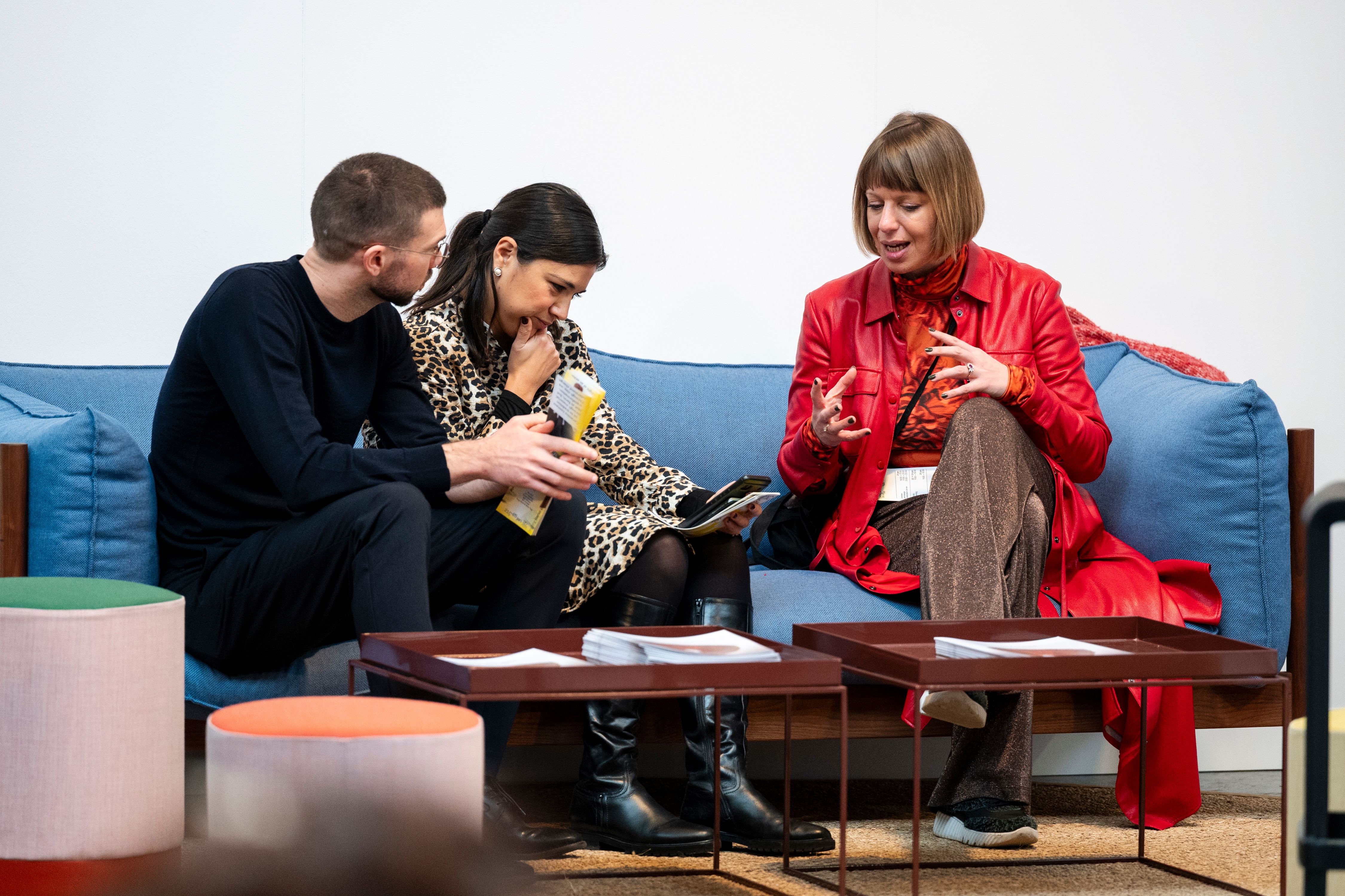 Guests talking on the sofas of the VIP lounge.