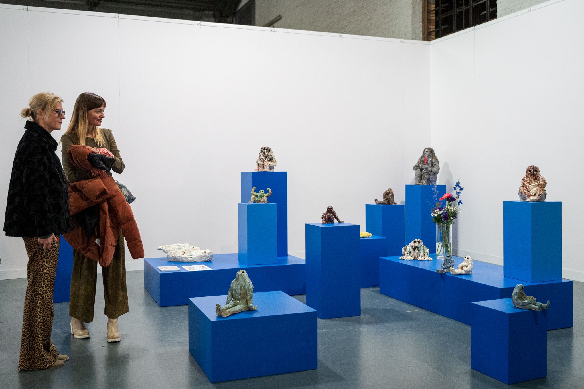 people in front of a booth during ceramic brussels 