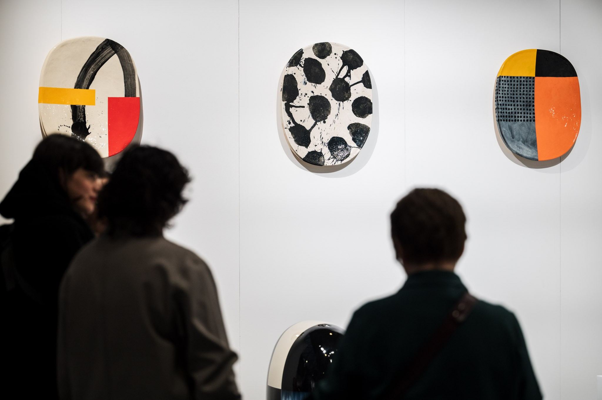 people in front of ceramic work of art 