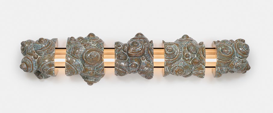 Sliced Cloud: five glazed ceramic fragments covered in spiral shells, threaded on a lit plexiglas rod.