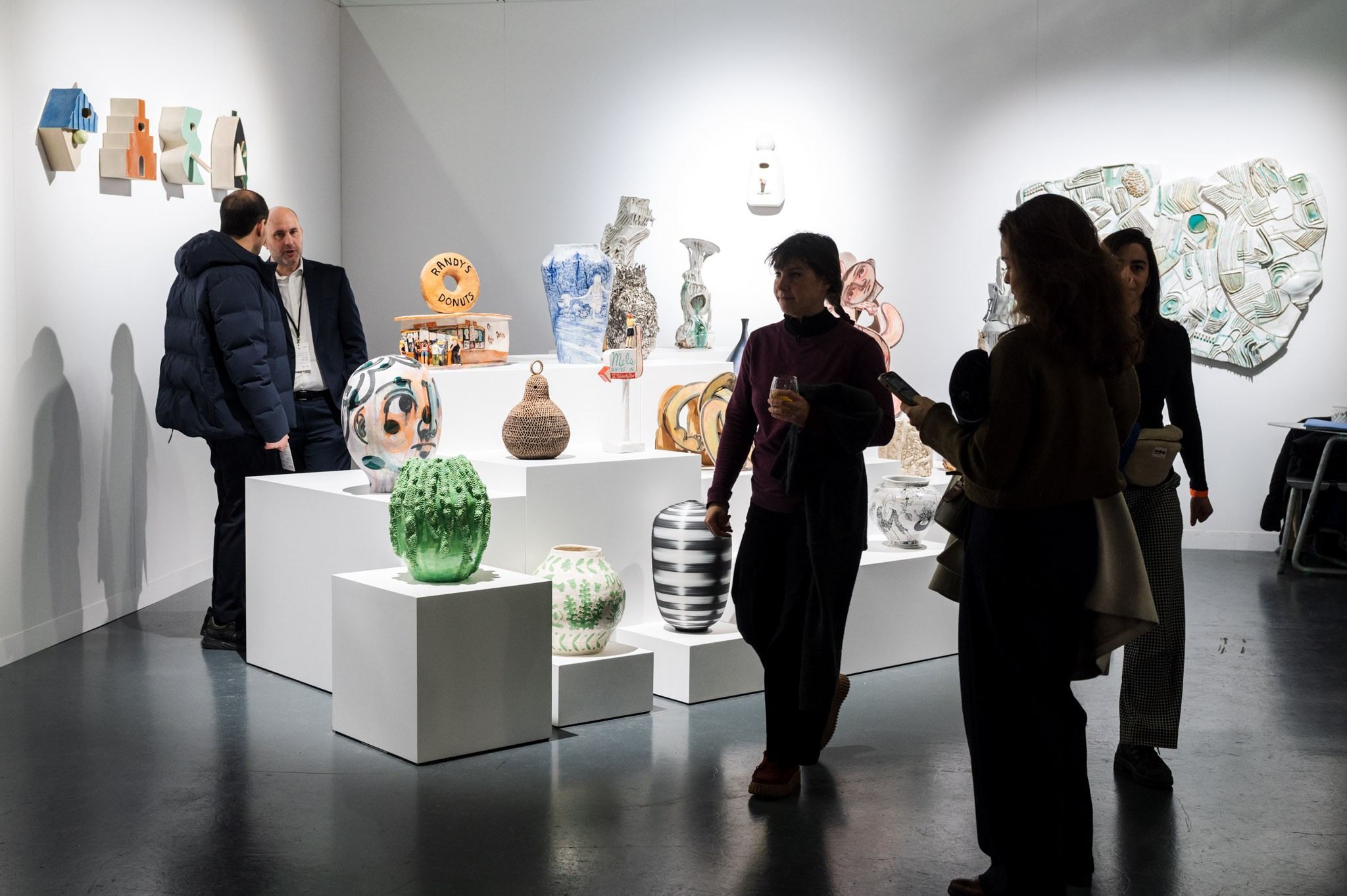 people in front of ceramic work of art 