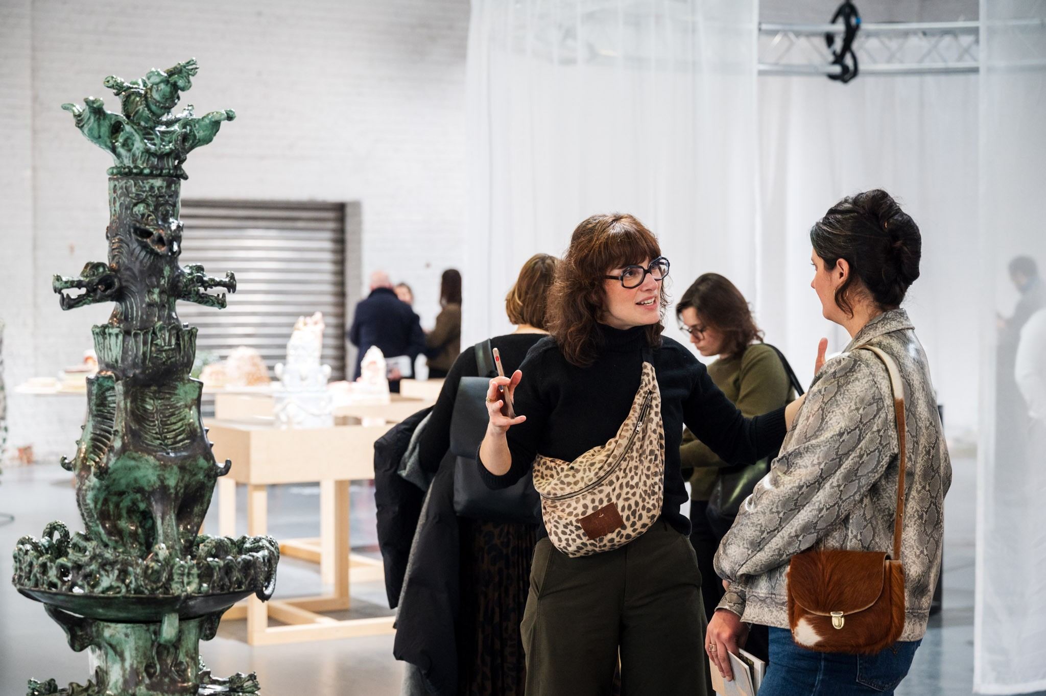 people in front of ceramic work of art 