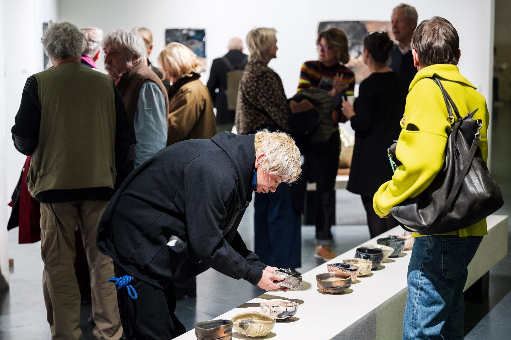 people in front of ceramic work of art 