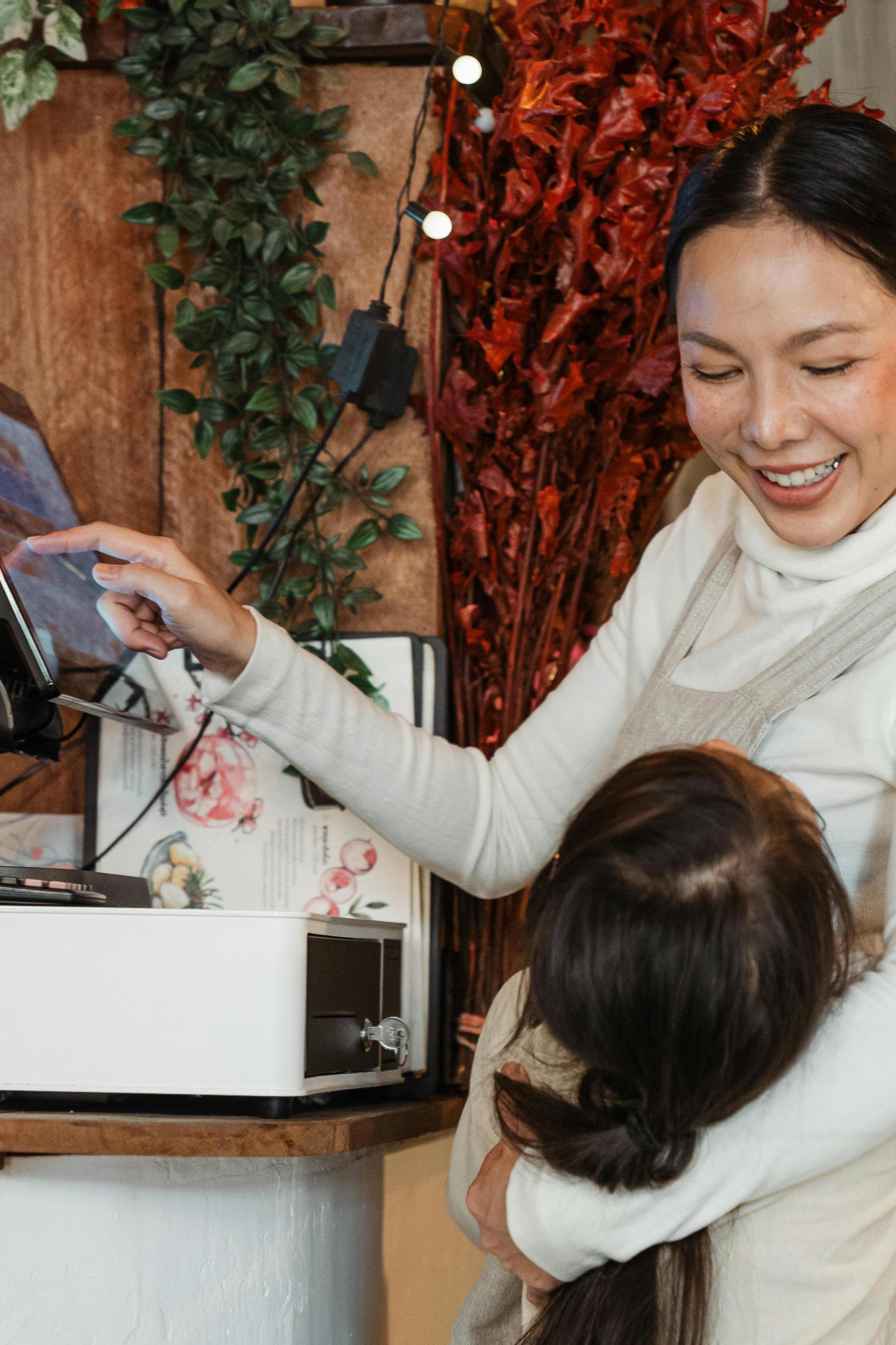 Mom smiling at daughter while working