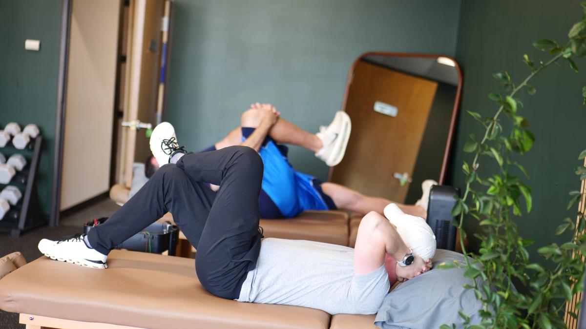 Patients stretching on treatment tables in the clinic