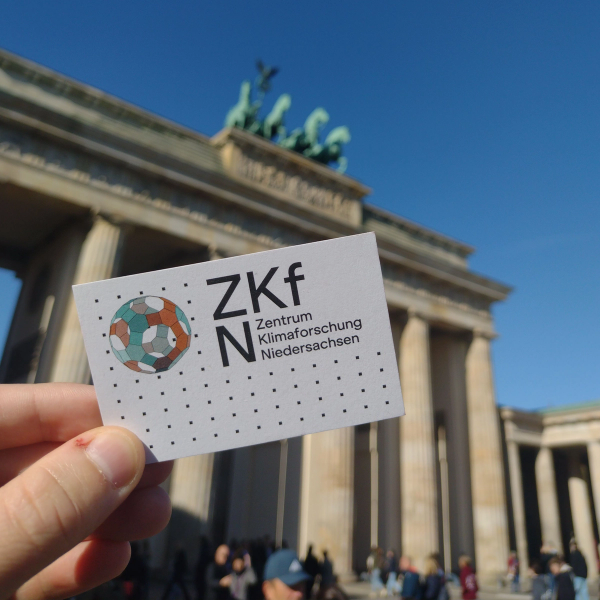 The ZKfN business card in front of the Brandenburg Gate in Berlin