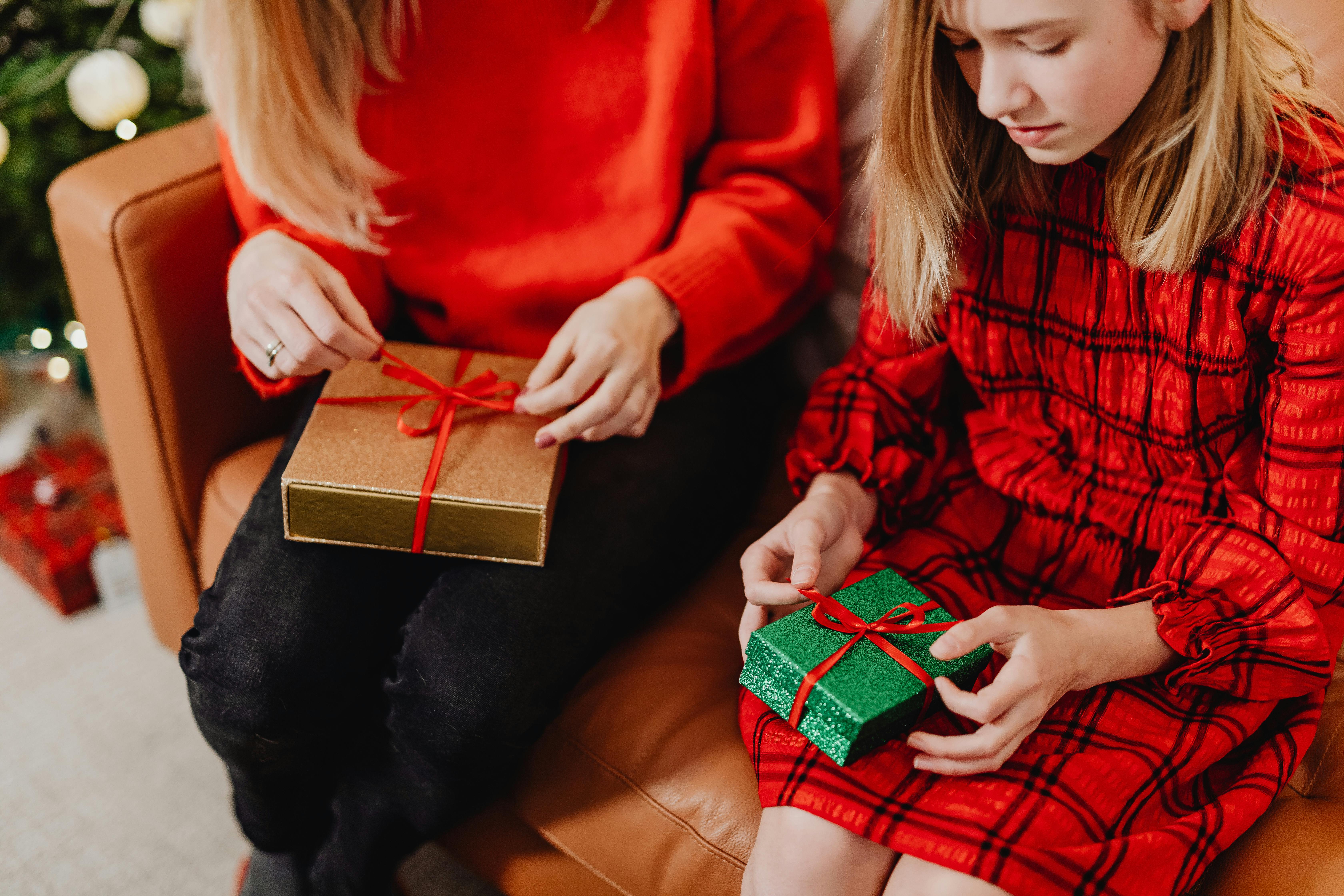 Mother and daughter opening holiday gifts