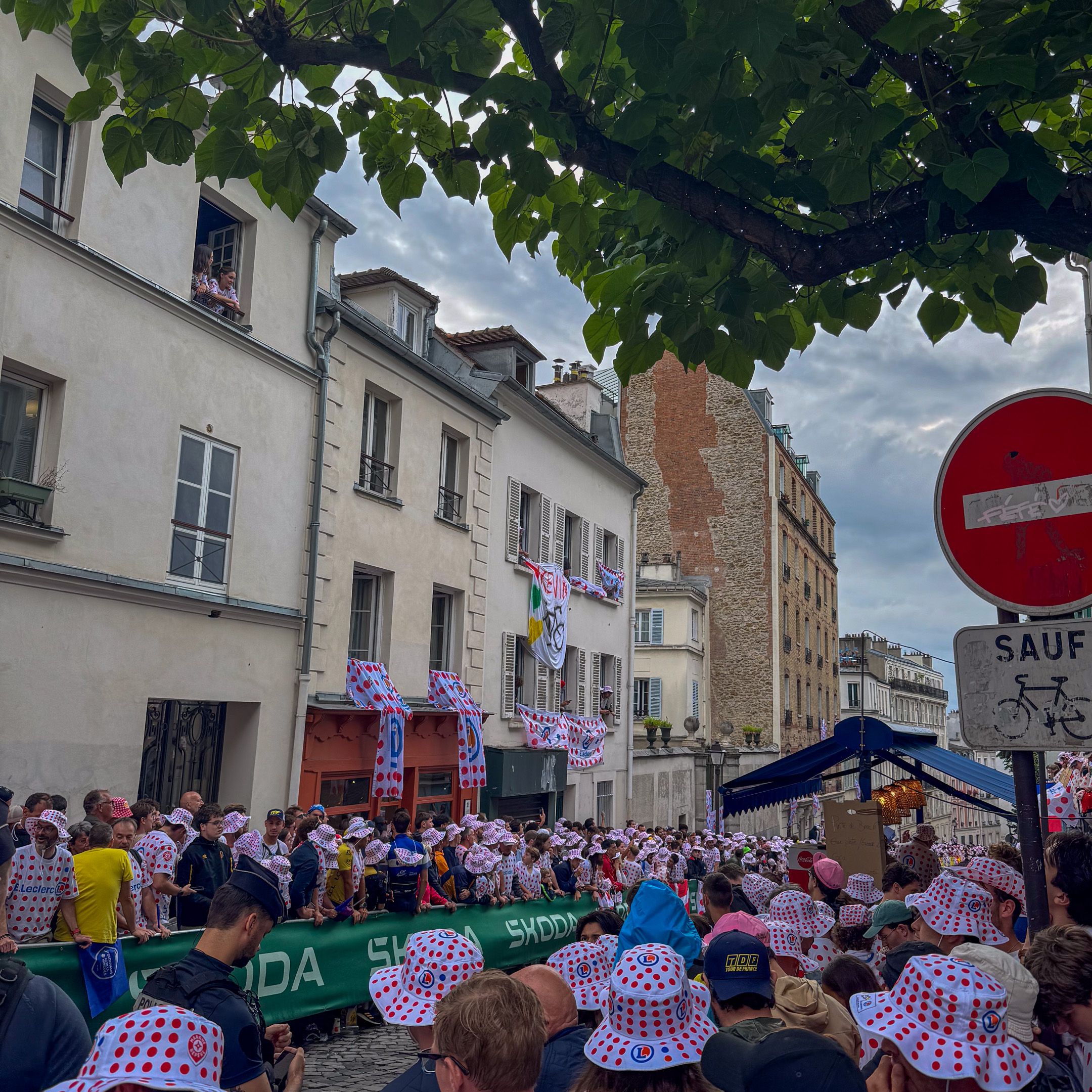 Spectators filling the narrow cobblestone street of Rue Lepic in Montmartre Paris, awaiting the cyclists fighting for the final stage win of Tour de France 2025