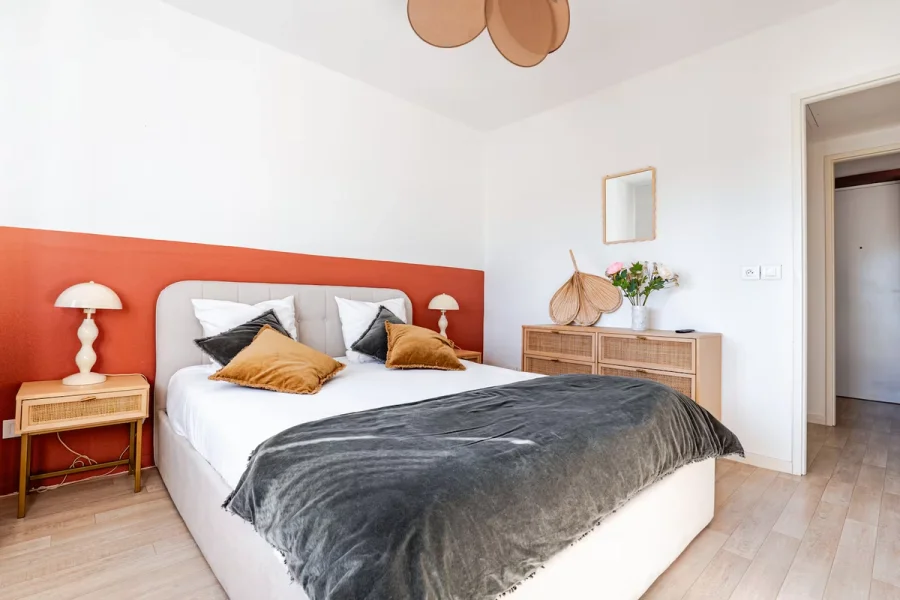 Vue d'ensemble de la chambre avec commode en cannage