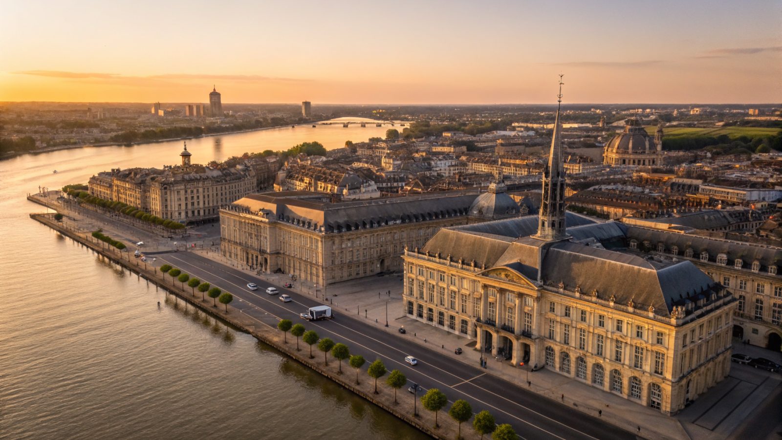 Vue aérienne du centre historique de Bordeaux avec la Place de la Bourse et le miroir d'eau, lumière dorée atlantique sur les façades calcaires