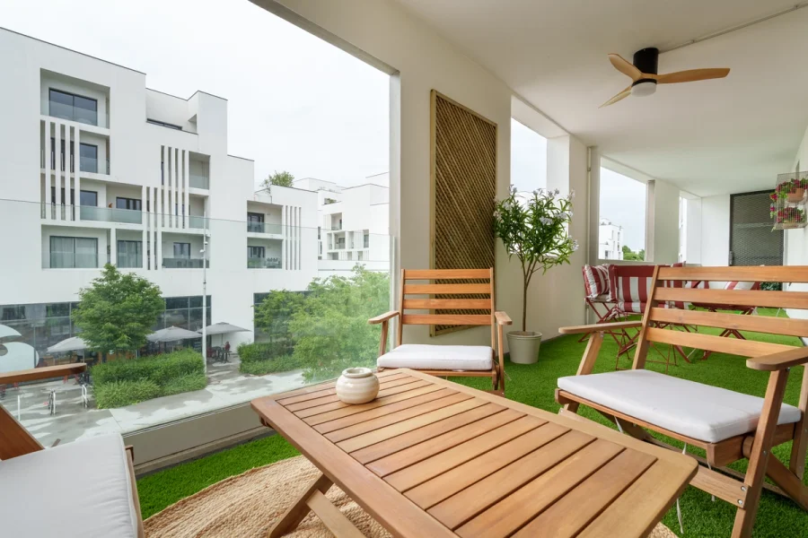 Salon extérieur en bois sur la terrasse avec vue sur l'esplanade