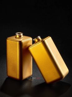 Two square perfume bottles in matte gold
