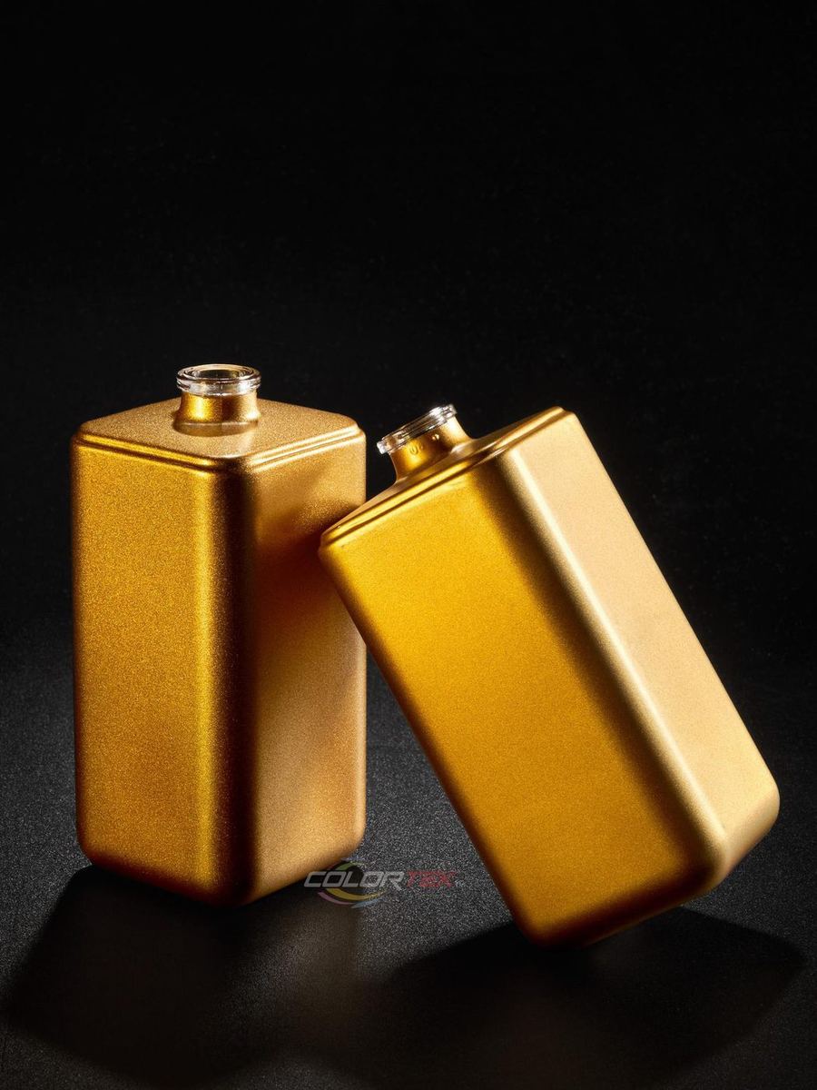 Two square perfume bottles in matte gold Colortek coating on black