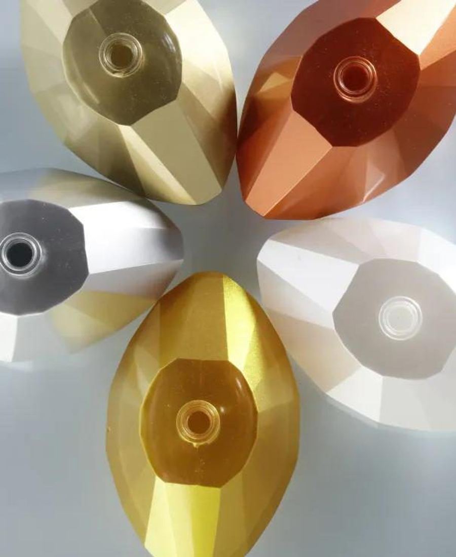 Faceted glass caps coated in gold, copper and silver metallic finishes