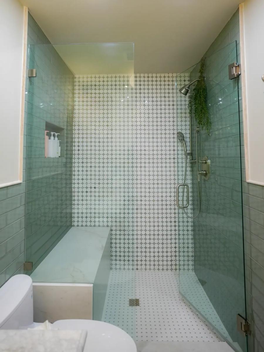 Frameless glass shower with sea-glass subway tile