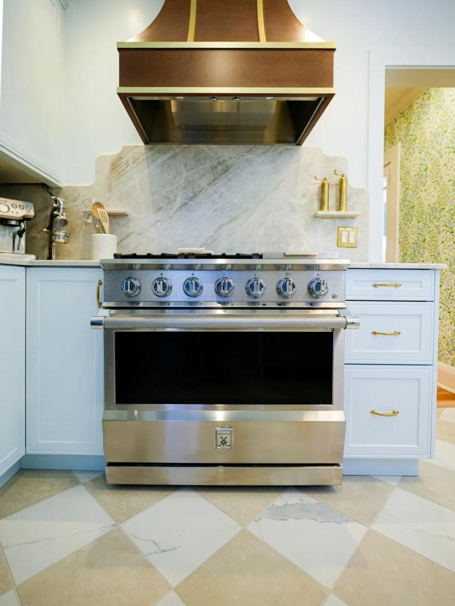 Professional range framed by a marble backsplash
