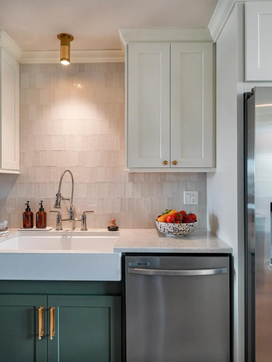 Farmhouse sink with a bridge faucet and white uppers