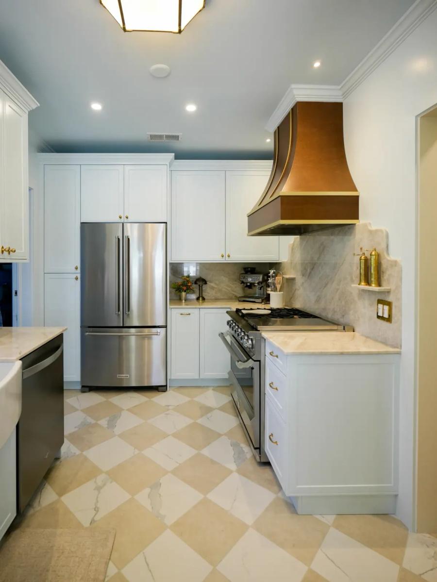 Historic-home kitchen with white shaker cabinets and a copper hood