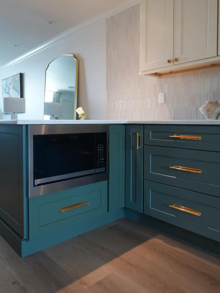 Teal corner cabinets with brass hardware