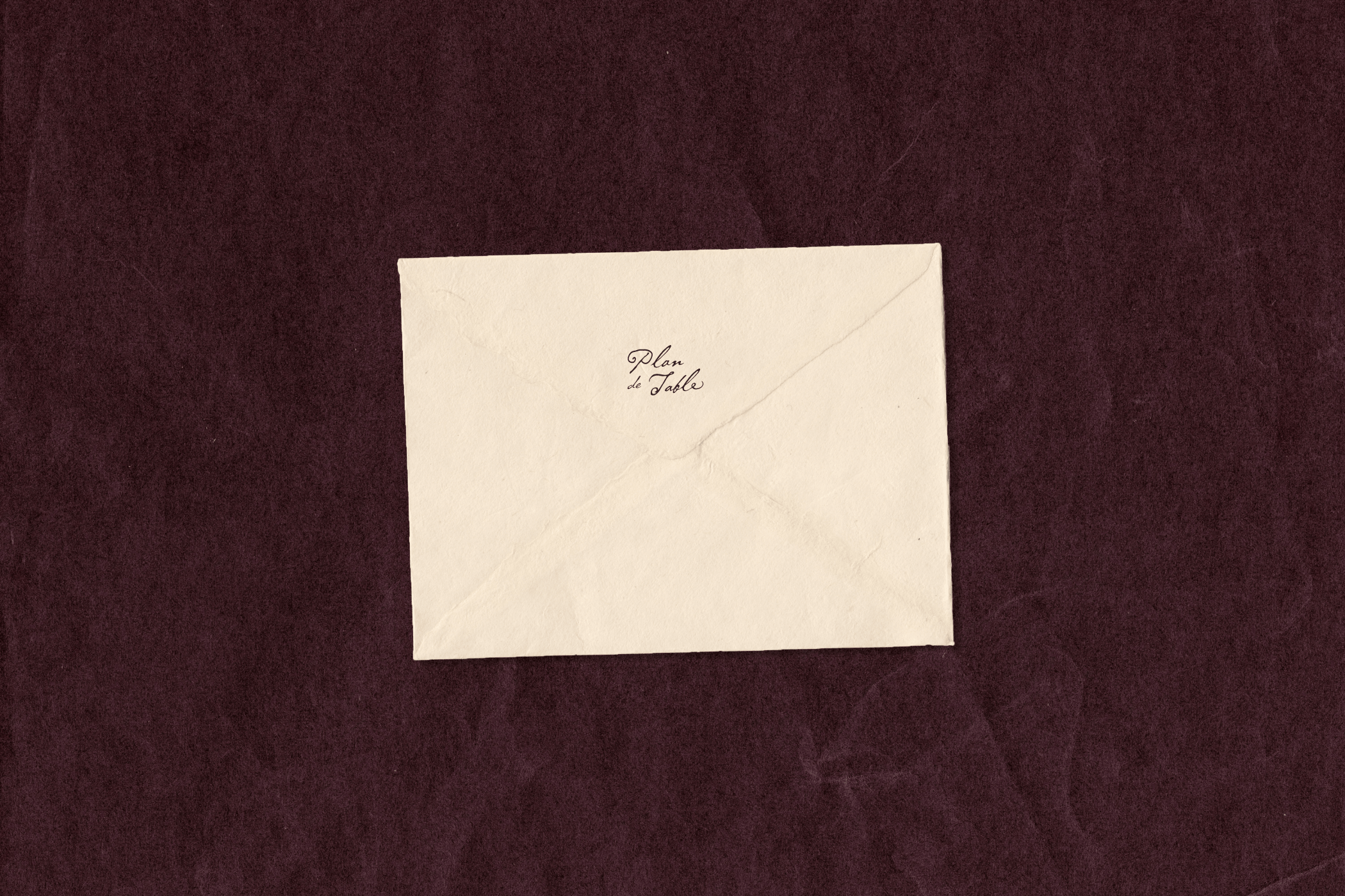 A cream envelope with logo, centered on a dark plum textured background.