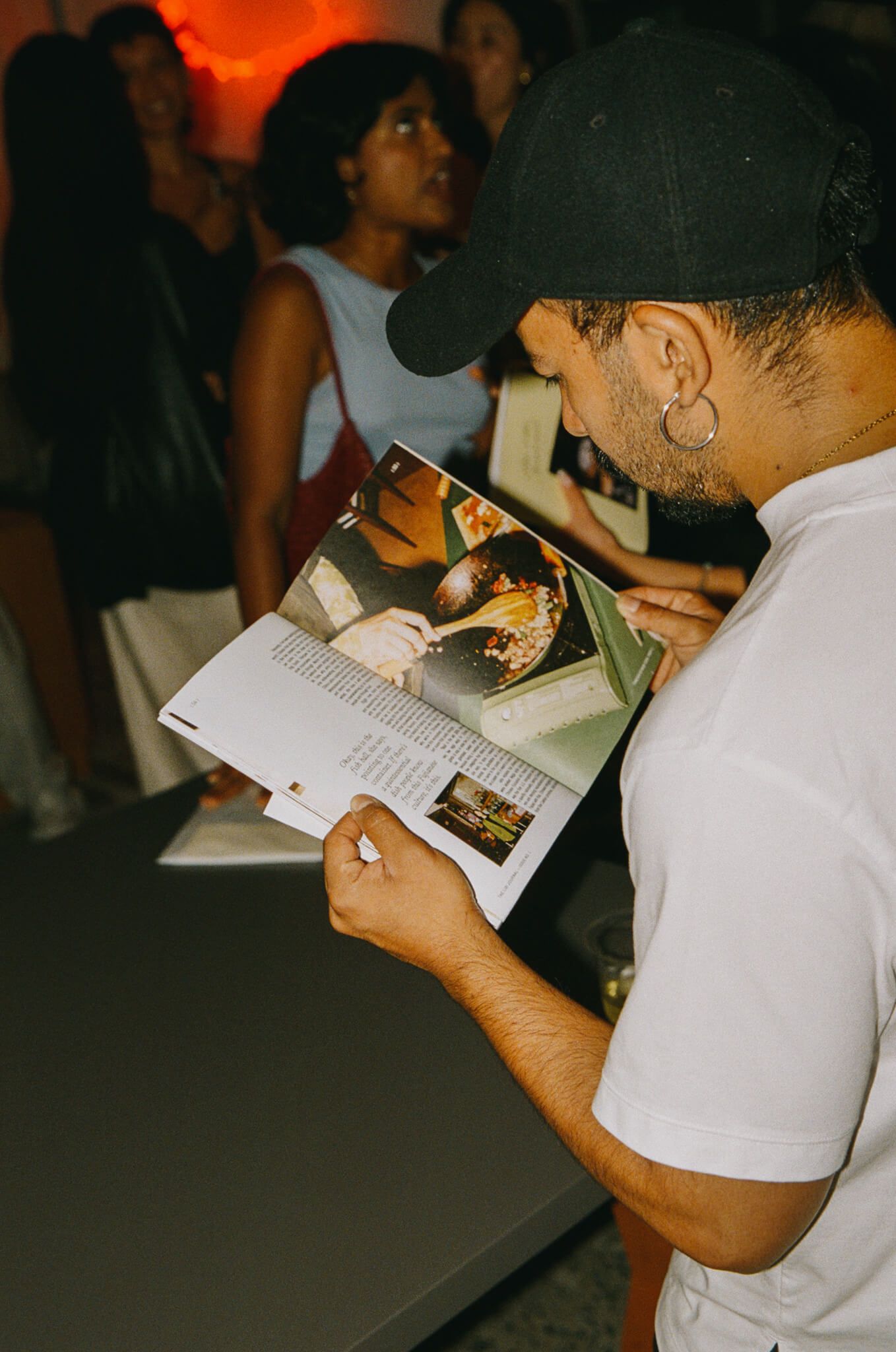 A guest reading an open copy of the journal at the party.