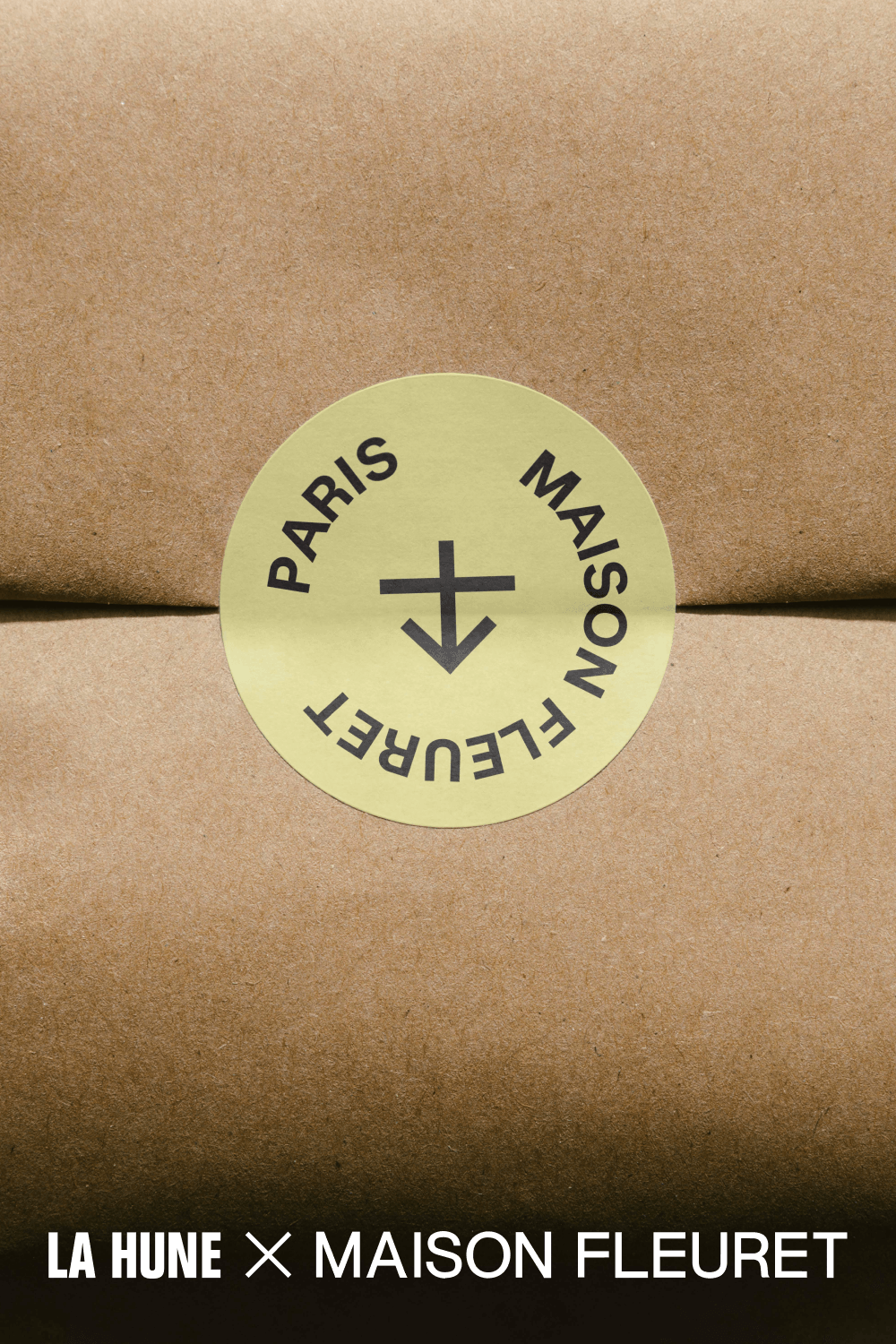 Kraft paper package sealed with a round sticker featuring the La Hune and Maison Fleuret names.