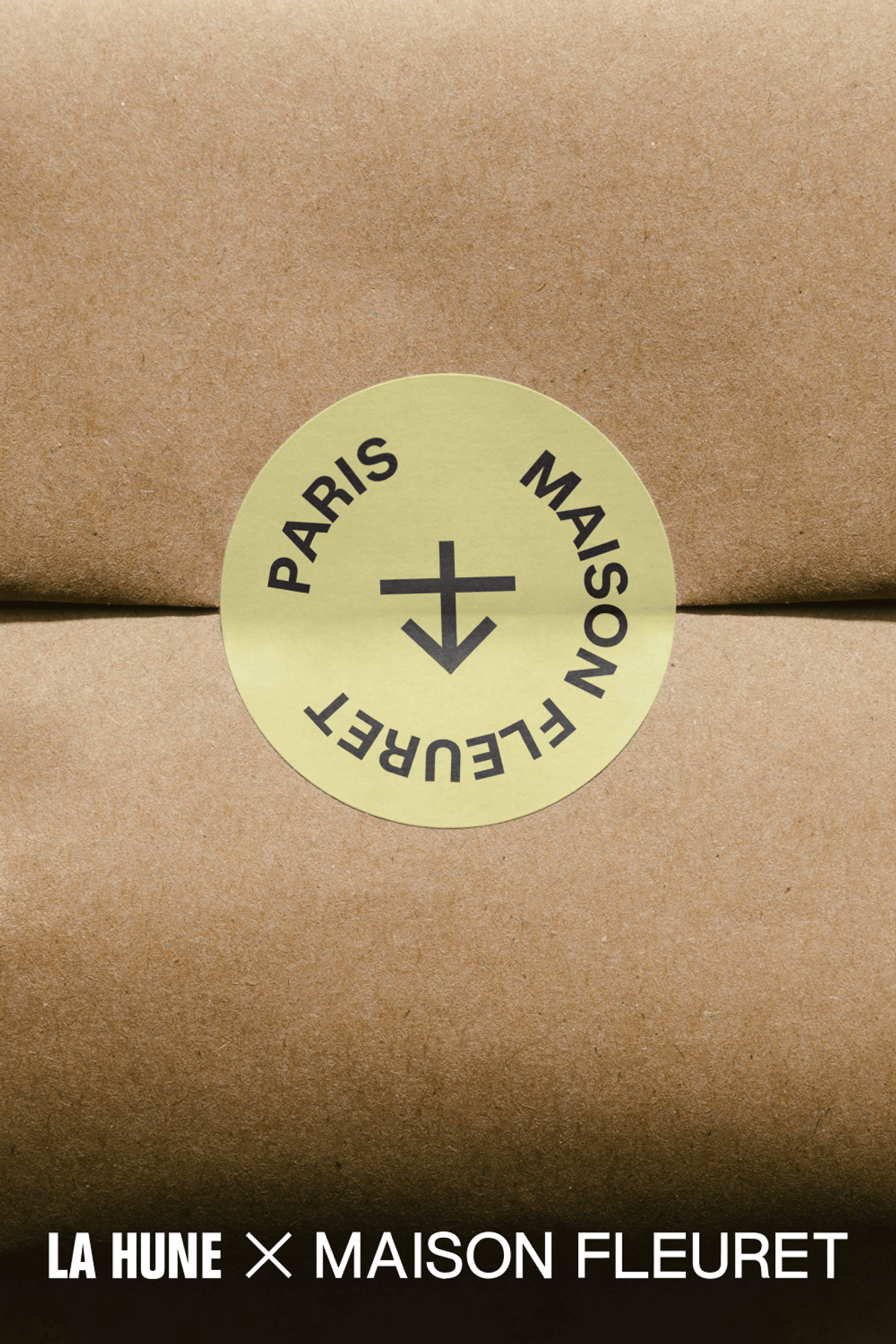 Kraft paper package sealed with a round sticker featuring the La Hune and Maison Fleuret names.