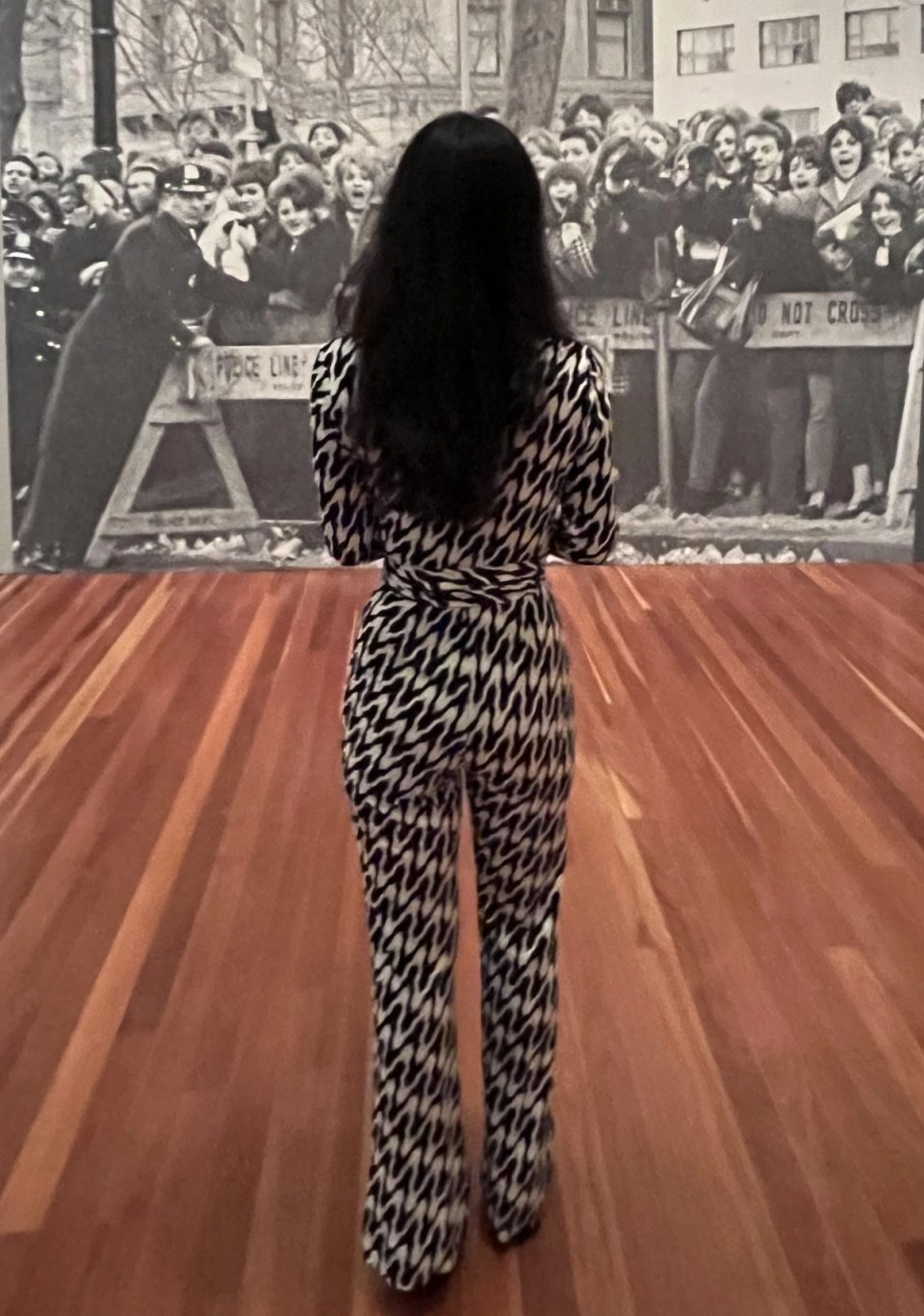 Duanni Hurd viewing a Beatles photograph at the Paul McCartney Eyes of the Storm press preview.