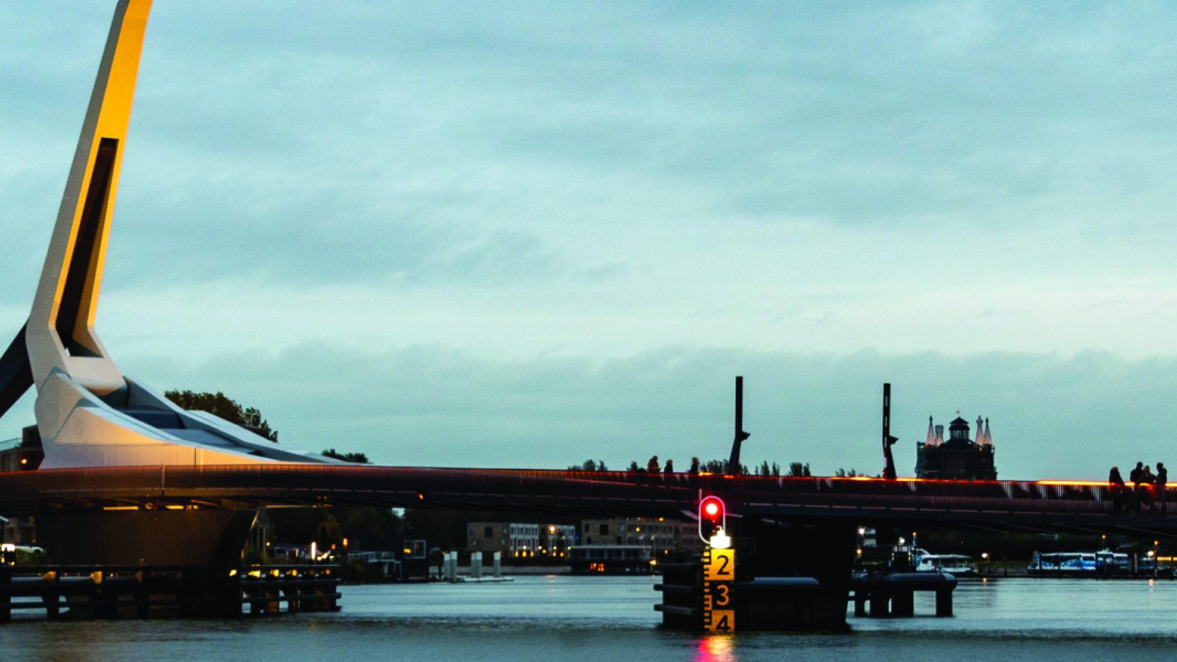 A movable bridge at dusk, lit against the water
