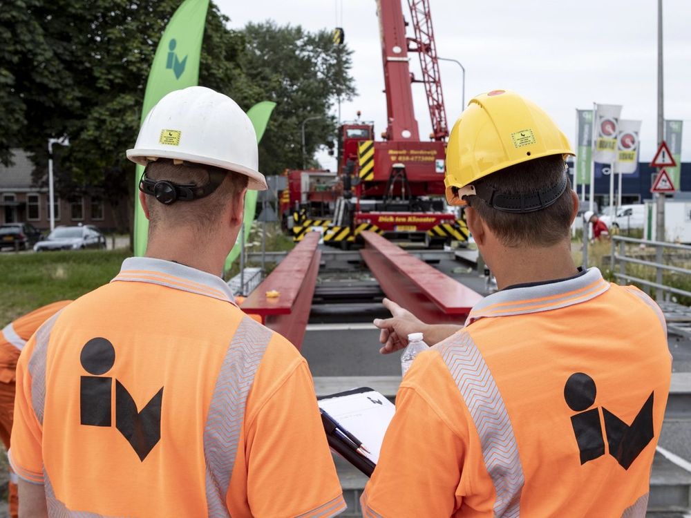 Iv engineers on site reviewing a lift of new bridge beams