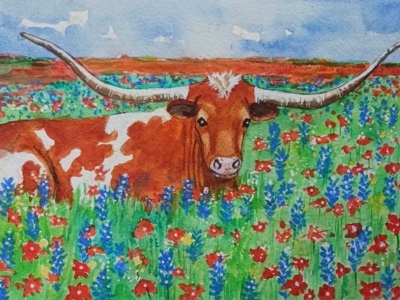 Longhorn in a field of bluebonnets and indian paintbrush