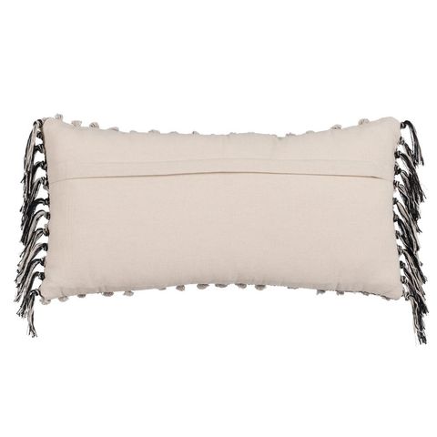 Reverso del cojín beige y negro con borlas