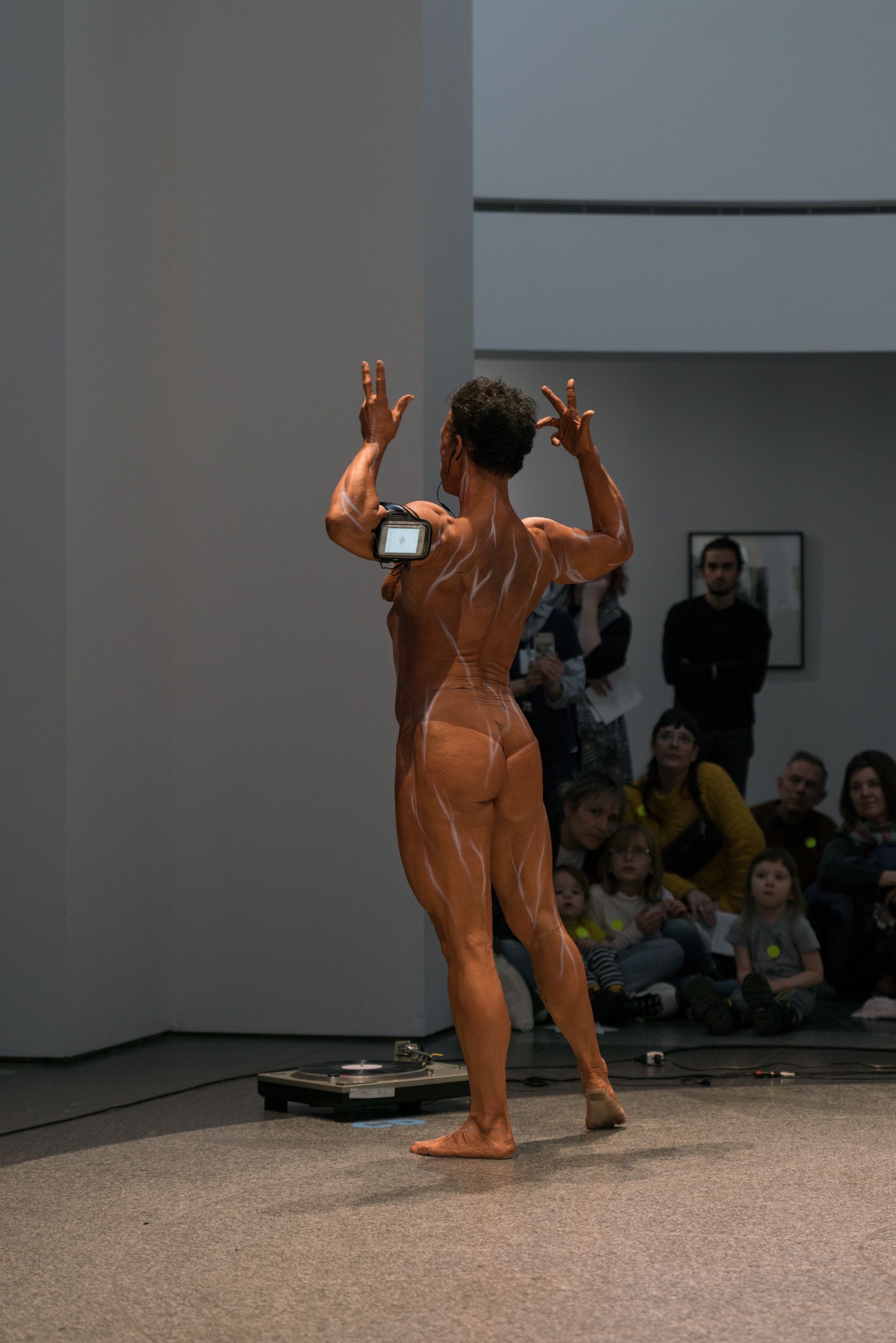 Female bodybuilder posing for PPKK 04.01 by Sarah Ancelle Schoenfeld and Louis-Philippe Scoufaras at Emerge MAC Montreal