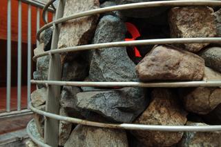 Close-up view of sidewalk rocks in sauna heater in PPKK 03.00 by Sarah Ancelle Schoenfeld and Louis-Philippe Scoufaras at Baerenzwinger Berlin