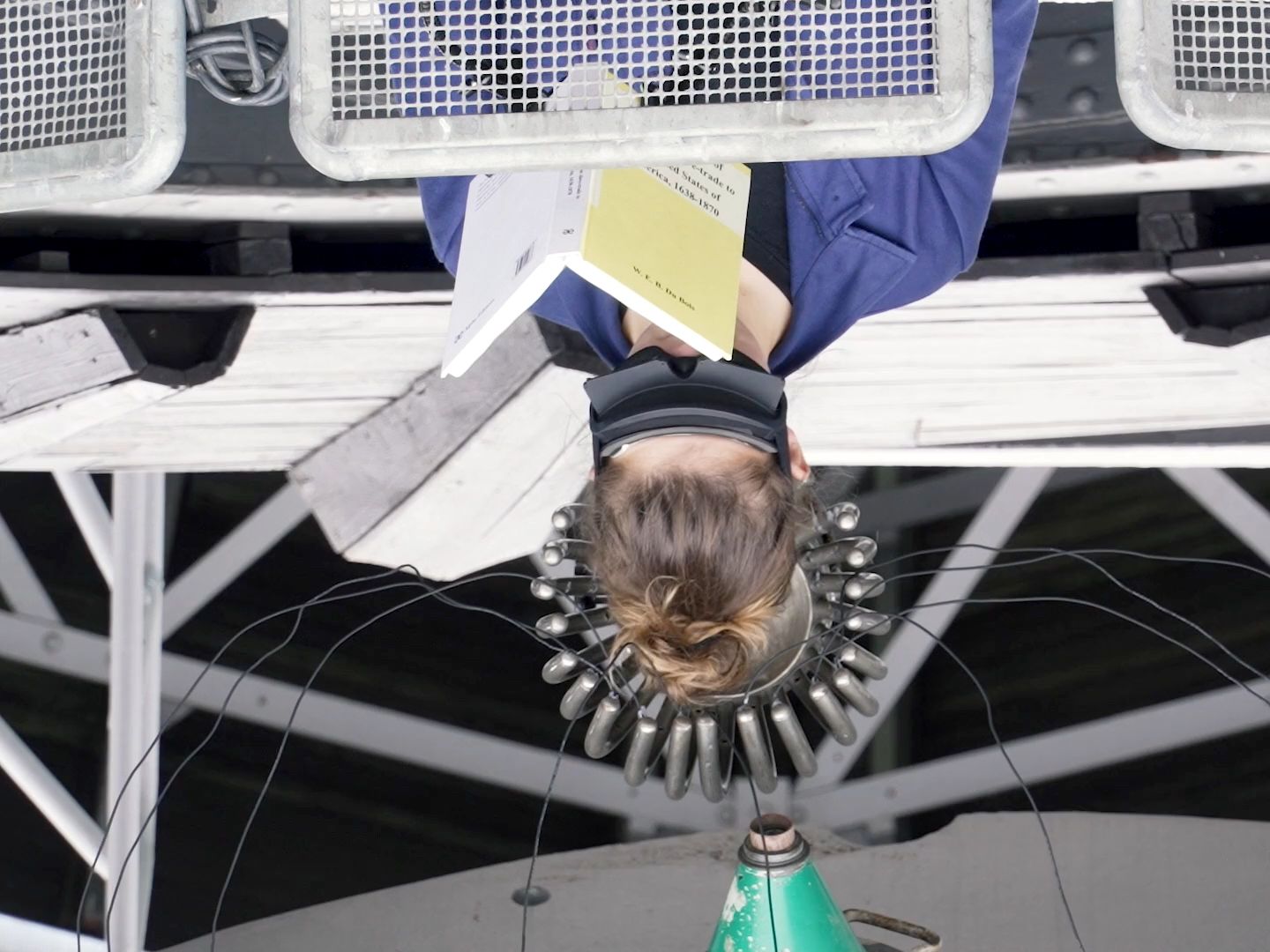 Film still of audience refractor reading performance for PPKK 07.00 by Sarah Ancelle Schoenfeld and Louis-Philippe Scoufaras