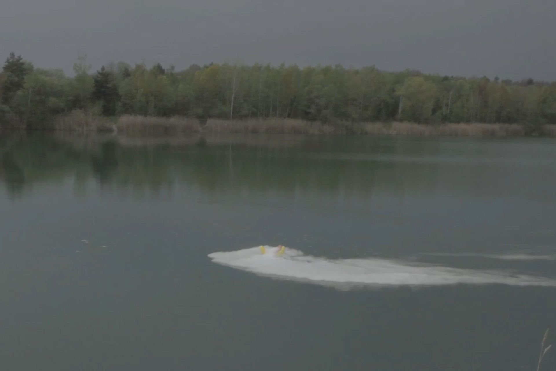 Film still of dancing pizza on lake for PPKK 01.00 by Sarah Ancelle Schoenfeld and Louis-Philippe Scoufaras in Pomssen