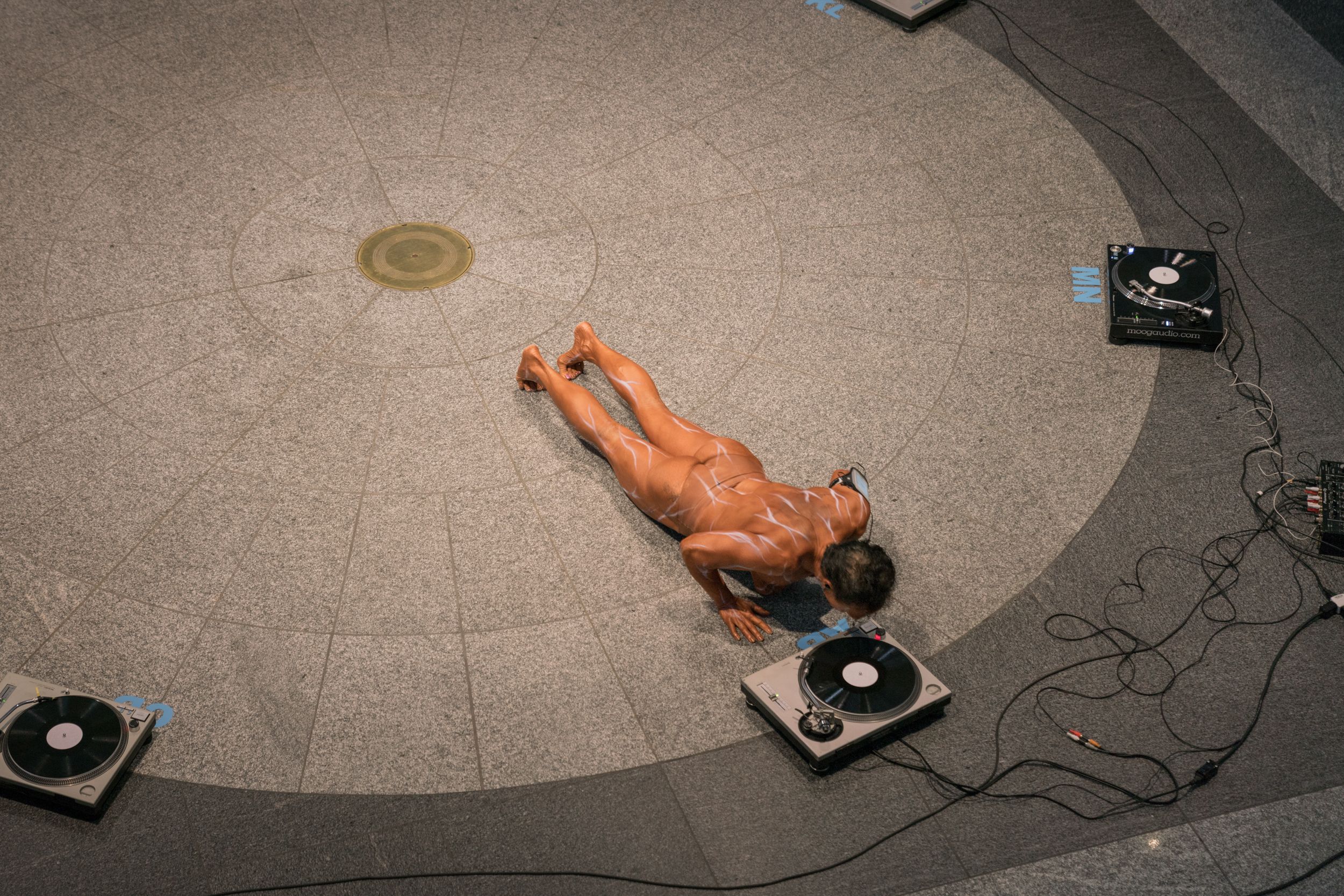 Female bodybuilder performing with record player for PPKK 04.01 by Sarah Ancelle Schoenfeld and Louis-Philippe Scoufaras at Emerge MAC Montreal